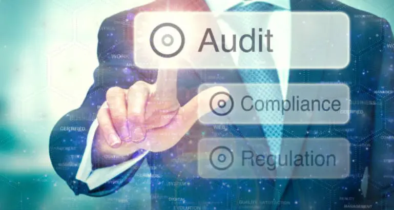 An individual taps on an audit icon with compliance and regulation icons to support business progress.
